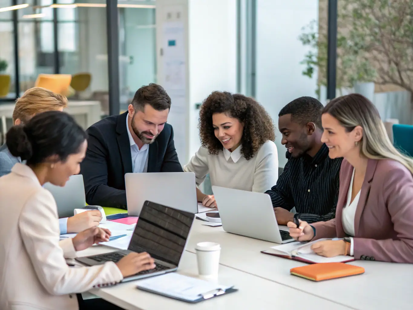 A diverse group of professionals working collaboratively in a modern office environment. The image should represent the wide range of talent Meridien Recruiters can source for its clients.