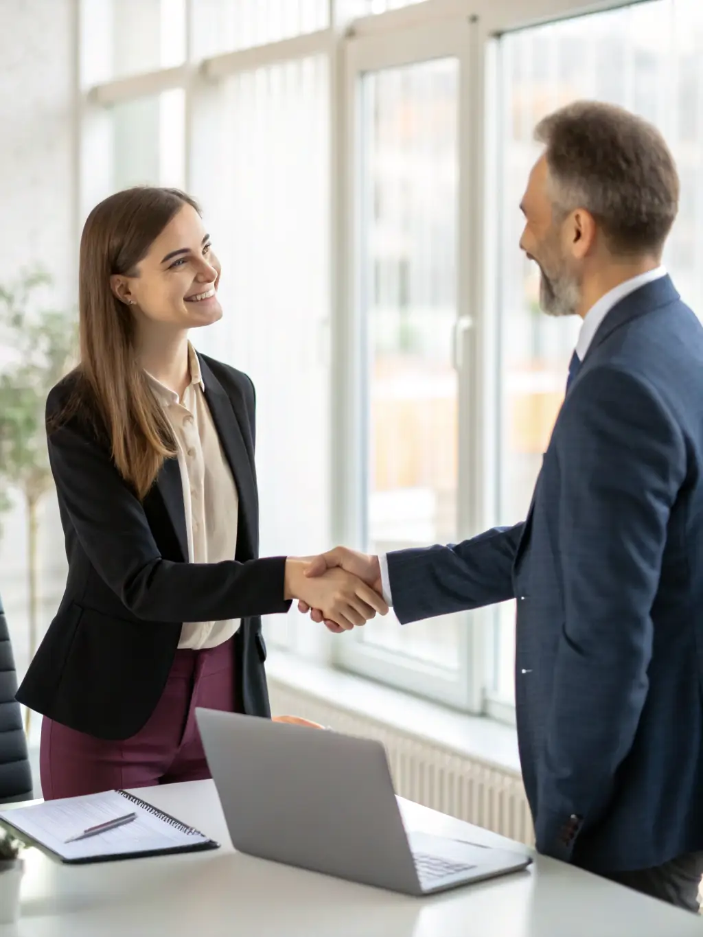 A candidate shaking hands with a hiring manager after a successful interview, symbolizing a positive recruitment outcome.